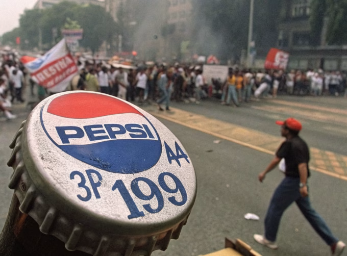 1990s Pepsi bottle cap with number 349 alongside protest scenes